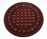 A traditional red rug with a geometric pattern 